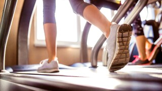 Detail of legs of woman running on treadmills gym